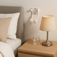 Med-Pat BR-31 Wall Mount Holder installed beside a bed, featuring a bedside lamp and glass of water.